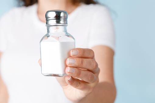 Woman showing salt shaker