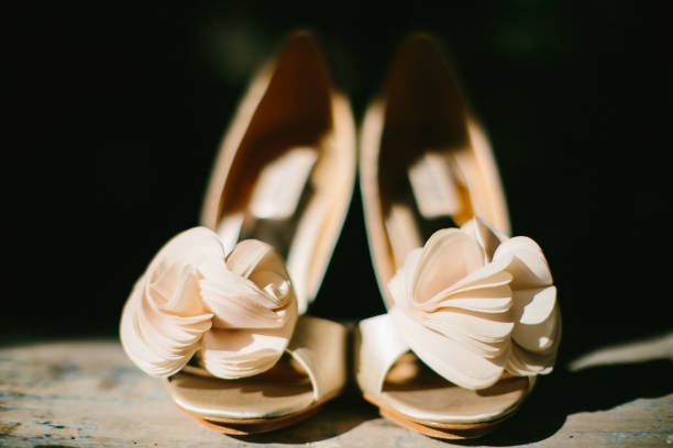 istock Beige wedding shoes on a wooden windowsill 1419508841