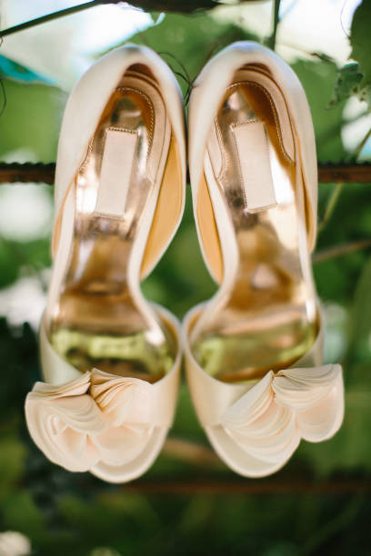 istock Beige wedding shoes hanging in the vineyard 1419508849