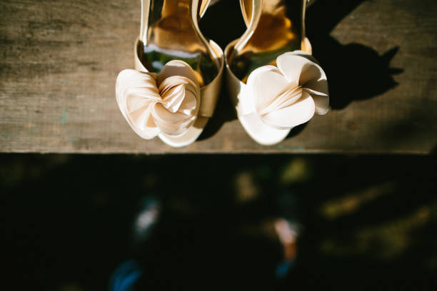 istock Beige wedding shoes on a wooden windowsill 1419508855