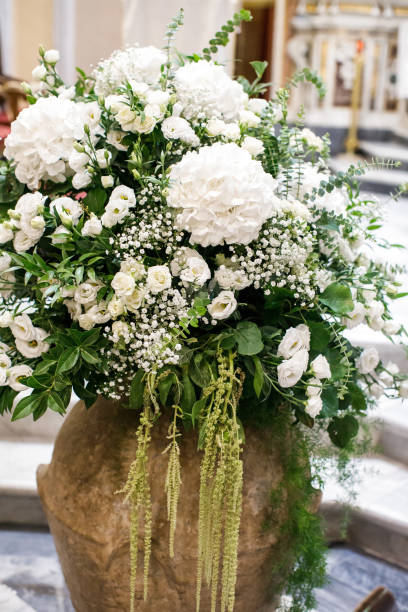 Delicate flowers in the vase at the wedding ceremony.