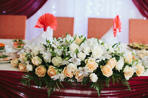 Bouquet of flowers in vase on the wedding table.