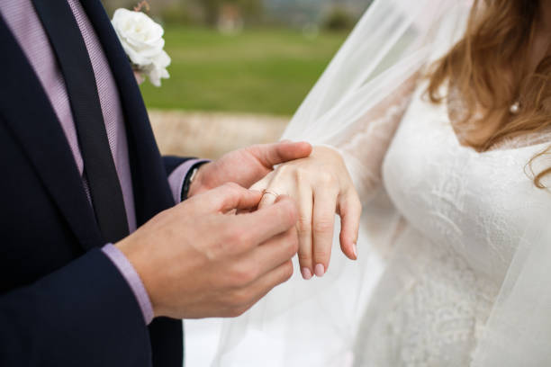 istock Bride and groom exchange rings at the wedding ceremony 1419509733