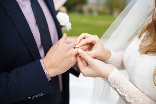 istock Bride and groom exchange rings at the wedding ceremony 1419509735