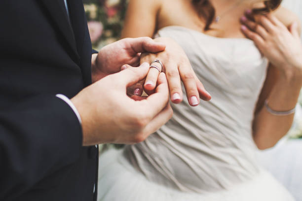istock Bride and groom exchange rings at the wedding ceremony 1419509776