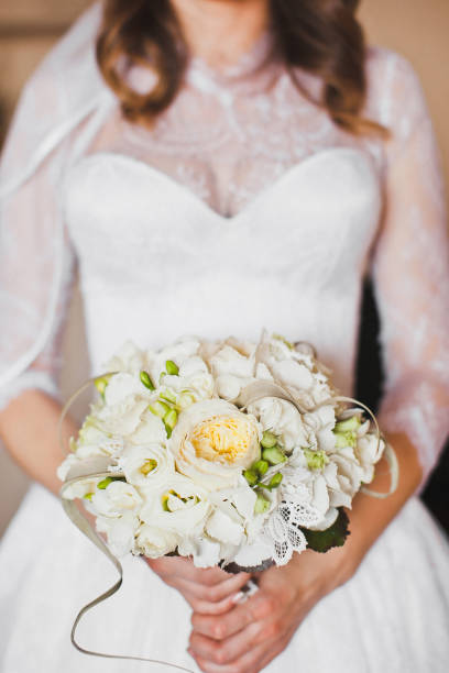 istock Bright wedding bouquet in hands of the bride 1419509811