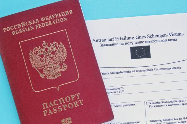 istock Passport and Schengen visa application form in Russian and Deutsch language on blue background 1419510223