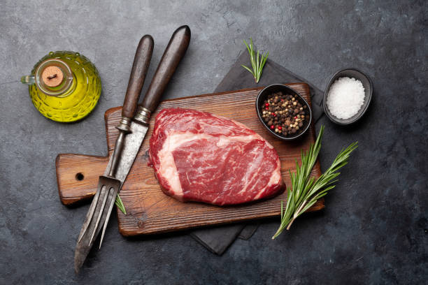istock Raw ribeye steak on cutting board 1419512197