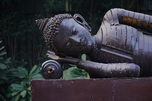 Nangloi, Delhi, India- 14 June 2022 :
Close up Sleeping buddha image made using iron
