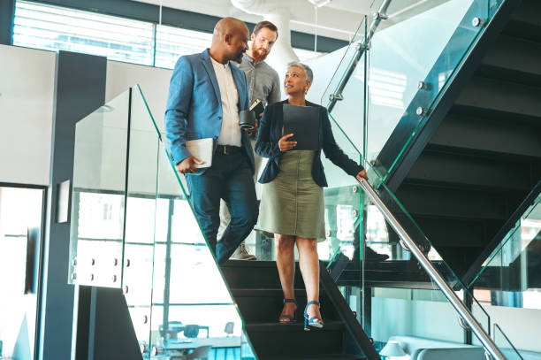 istock Ceo, leader or manager talking with team about business, strategy or planning. Coaching, leadership and training working people on trust, teamwork and innovation at the company, office or building. 1419522270