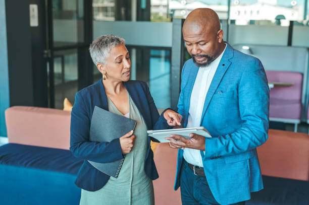 istock Leadership, management and teamwork with a CEO and corporate manager working in collaboration on a job. Talking about the vision and mission of their company and planning the growth of their business 1419524041