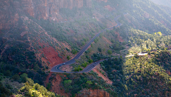 Aerial view overlooking a winding road in the Zion National Park at the Canyon Overlook. Seen a hot day in the Summer.