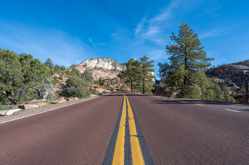 Aerial view overlooking a straight road in the Zion National Park at the Canyon Overlook. Seen a chill afternoon in the spring.