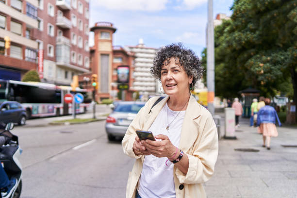 istock A mature woman using her smartphone to order a cab with an app 1419525586
