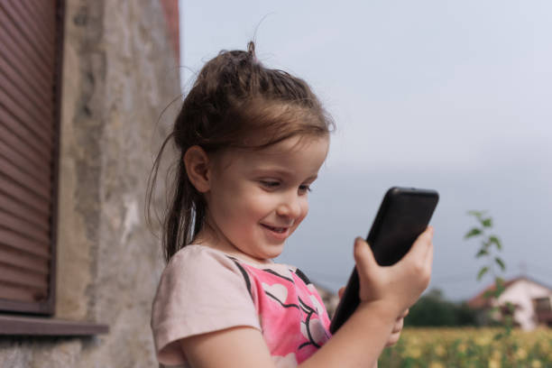 istock Girl using mobile phone outdoors 1419526010