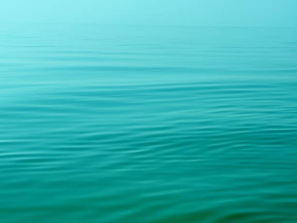 Blue sea water calm rippled surface background.