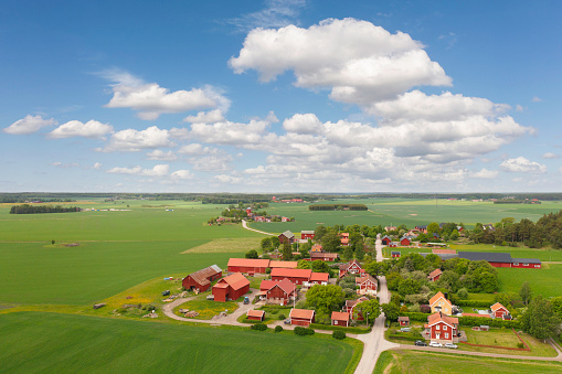 Brunnsta village and a countryside landscape with green fields in the Uppland province of Sweden.