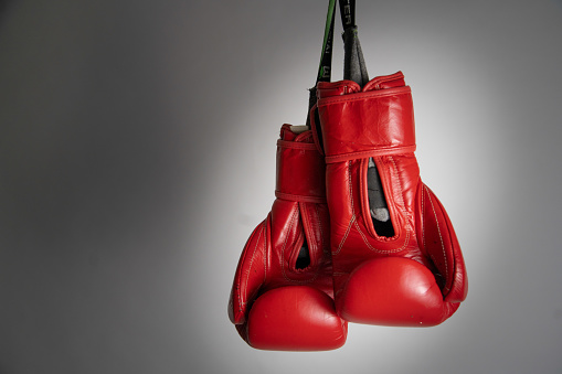 boxing sport concept hanging red boxing gloves