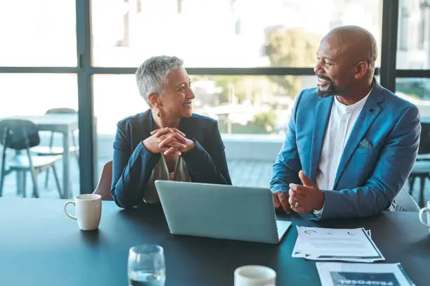 Photo of Leadership, management and teamwork between CEO and senior manager in a business meeting in the office. Leader and boss working as a team to plan the vision and mission for growth and development