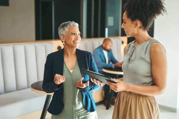 Communication, consulting and planning, business women meeting in the work lobby. A woman in leadership, ceo, team leader or coaching mentor, collaboration and motivation for office employee success stock photo