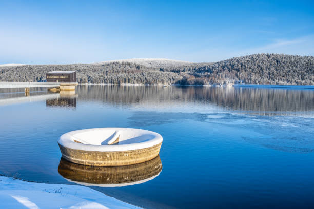 Winter scenery with mountain forests and water reservoir Spruce forests of Jizera Mountains reflected in Josefuv Dul Dam on sunny winter day, Czech Republic czech republic mountains stock pictures, royalty-free photos & images