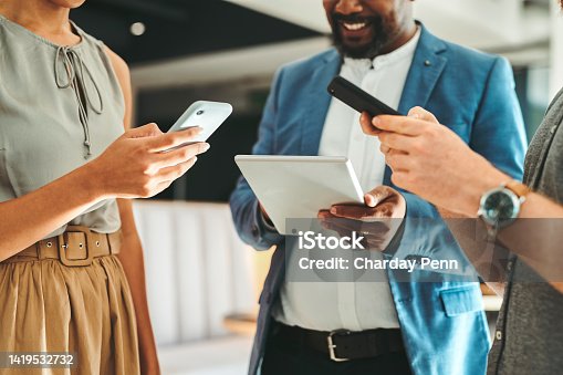 istock Diversity in working team using internet on phones and digital tablet for teamwork growth in the office. Professional staff work with 5g technology to match work schedule online the company website 1419532732