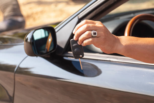 istock Car key in a man's hand with car. 1419535247