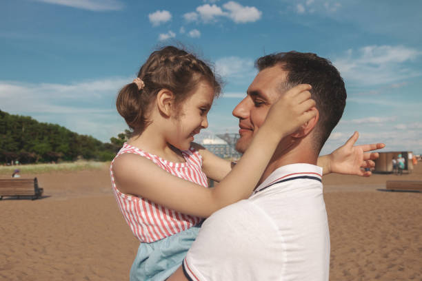 istock little happy daughter hugs daddy on sunny day 1419536028