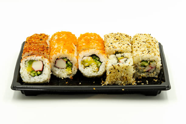 istock Four types of sushi on plastic black plate on white background 1419538033