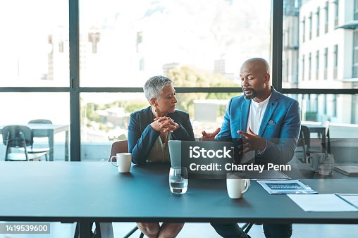 istock Business, presentation and man on a laptop in a corporate conference or office collaboration with a woman at work. Businessman, manager or coach for marketing, strategy and sales working with CEO. 1419539600