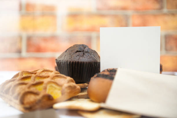 Bright pastries on a wooden backdrop template with empty white business card