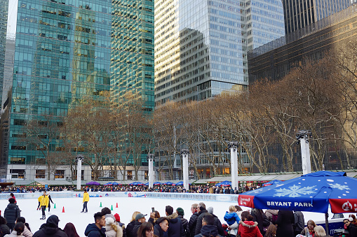 New York, USA - December 25, 2019: People waiting to skate on rink of Bryant Park in Midtown Manhattan on Christmas Eve. Favorite entertainment of local and tourists on Xmas in winter Holidays in NY