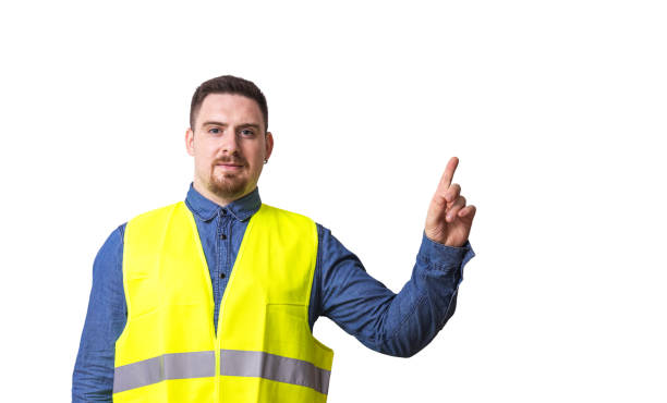istock Young man in safety vest is pointing at a copy space 1419551688