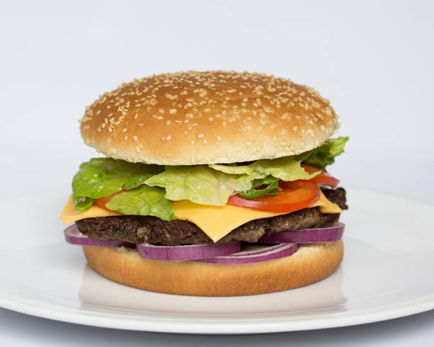 istock American cuisine. Fast food. Burger on a white background. Cheeseburger. Menu 1419554644
