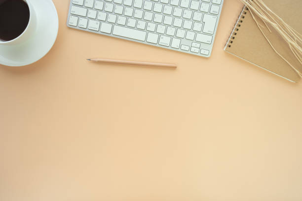 istock Flat lay of top view desk work table with Coffee computer notebook and pencil work space in minimal orange color autumn tone concept includes copyspace for add text or graphic 1419555552