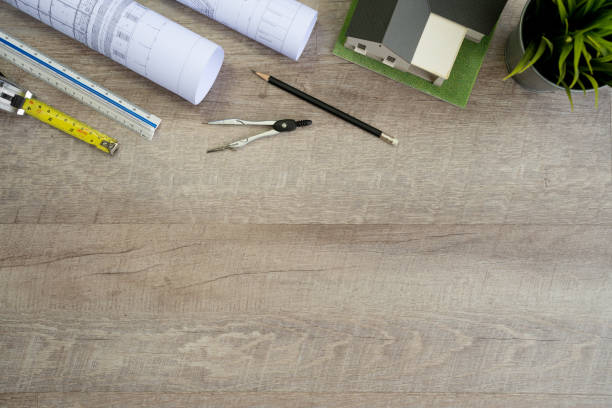istock Flat lay of top view desk work table Engineer with Blueprint drawing,Yellow Helmet,architect design stationary and house model mock up in Engineer Architect concept includes copyspace for add text or graphic 1419555559