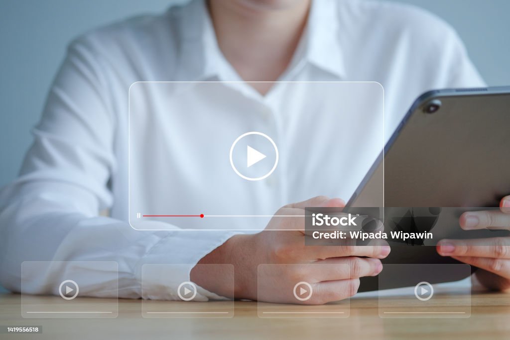 Video streaming on internet. Watching online movie, TV series, live concert, show or tutorial on tablet screen. Multimedia player. Subscription based live digital stream or channels. Replay Stock Photo
