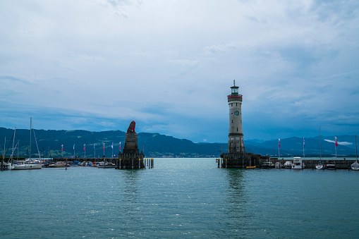 Germany, Lindau lighthouse port ancient buildings at bodensee lake with view to austrian coastline