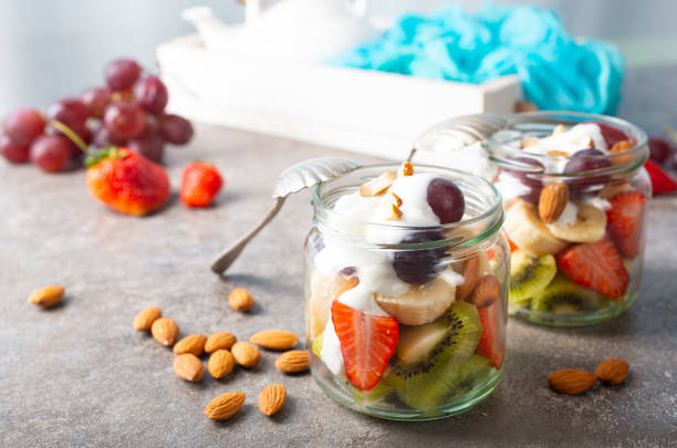 Summer fruit salad with white cream and almonds stock photo