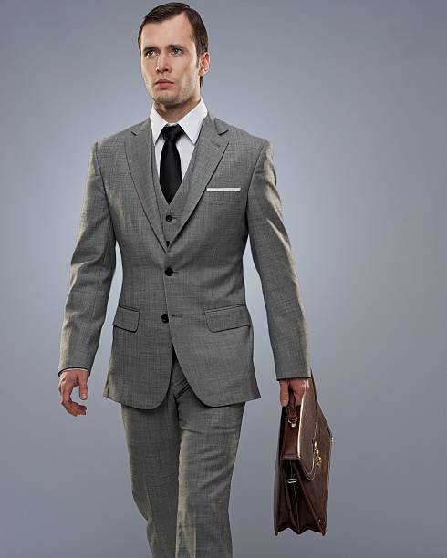 istock Businessman with a briefcase isolated on grey. 141955768