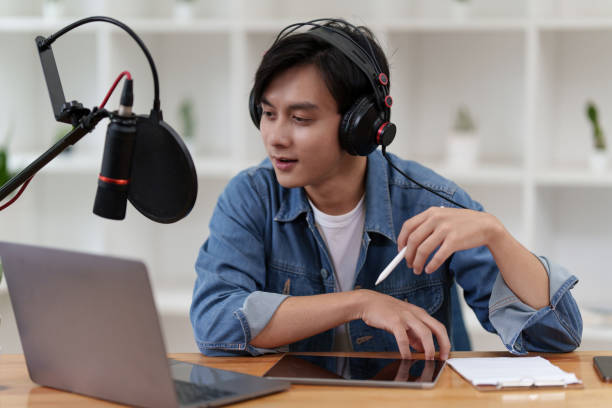 istock Asian podcaster making audio podcast working at home studio 1419557964