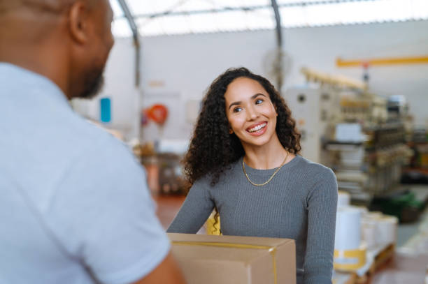 istock Logistics, shipping and distribution warehouse while factory workers exchange a package, box or parcel for b2b delivery. Happy female manager taking inventory or online order for shipping 1419558140