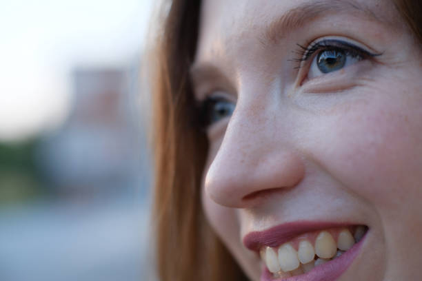 Young female eyes and smile closeup with copy space with blurred background