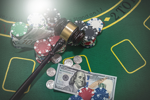 Happy Man in a Suit Standing in the Middle of a Modern Casino, Extending Arms, Welcoming a Money Rain.Young Male Smiling, Celebrating His Victory. Embodiment of a Successful Man