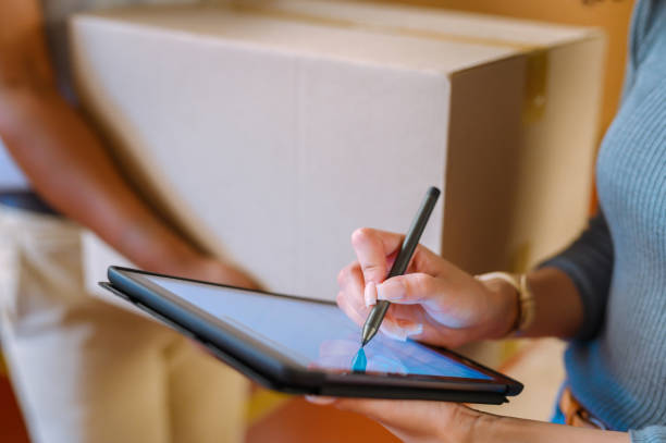 signing logistics delivery on tablet by a manager, shipping warehouse and factory worker. closeup of industry store leader working on supply chain manufacturing cargo and writing with digital stylus - contract signing document legal system imagens e fotografias de stock