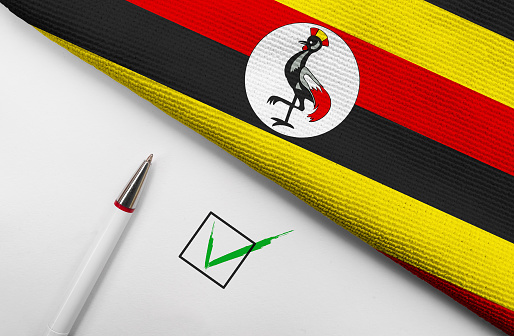 Pencil, Flag of Uganda and check mark on paper sheet