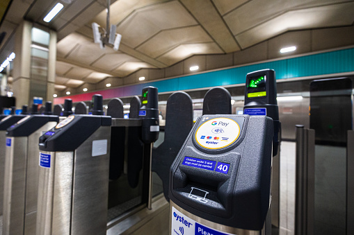 London, UK - 25 August, 2022: modern electronic ticket barriers equipped with contactless payment touchpads at Battersea Power Station underground station in London, UK.