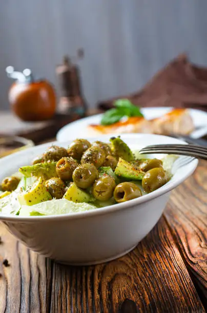 Photo of Greek salad. Fresh vegetable salad of cucumbers, tomatoes, olives, onion