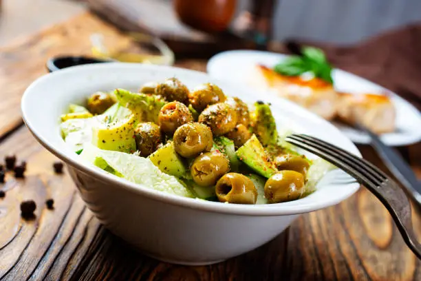 Photo of Greek salad. Fresh vegetable salad of cucumbers, tomatoes, olives, onion