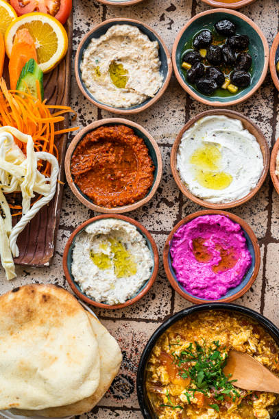 istock Traditional Turkish Village Breakfast on the ceramic table with pastries, vegetables, greens, spreads, cheeses, fried eggs, jams. Top view 1419570859